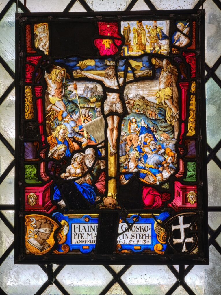 Stained glass with crucifixion in the Knights' Hall